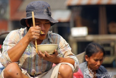 A local in Mekong Delta enjoying lunch - Mekong Tour in Vietnam