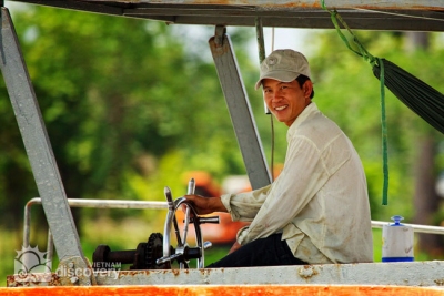 Happy man on Saigon River - tour to Cu Chi by speedboat