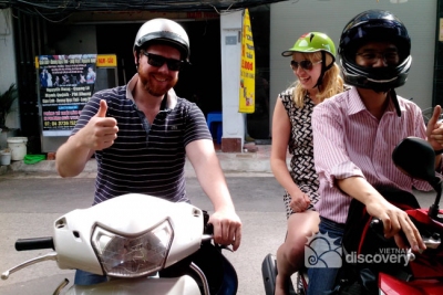 Happy couple with Hanoi tour on motorbike